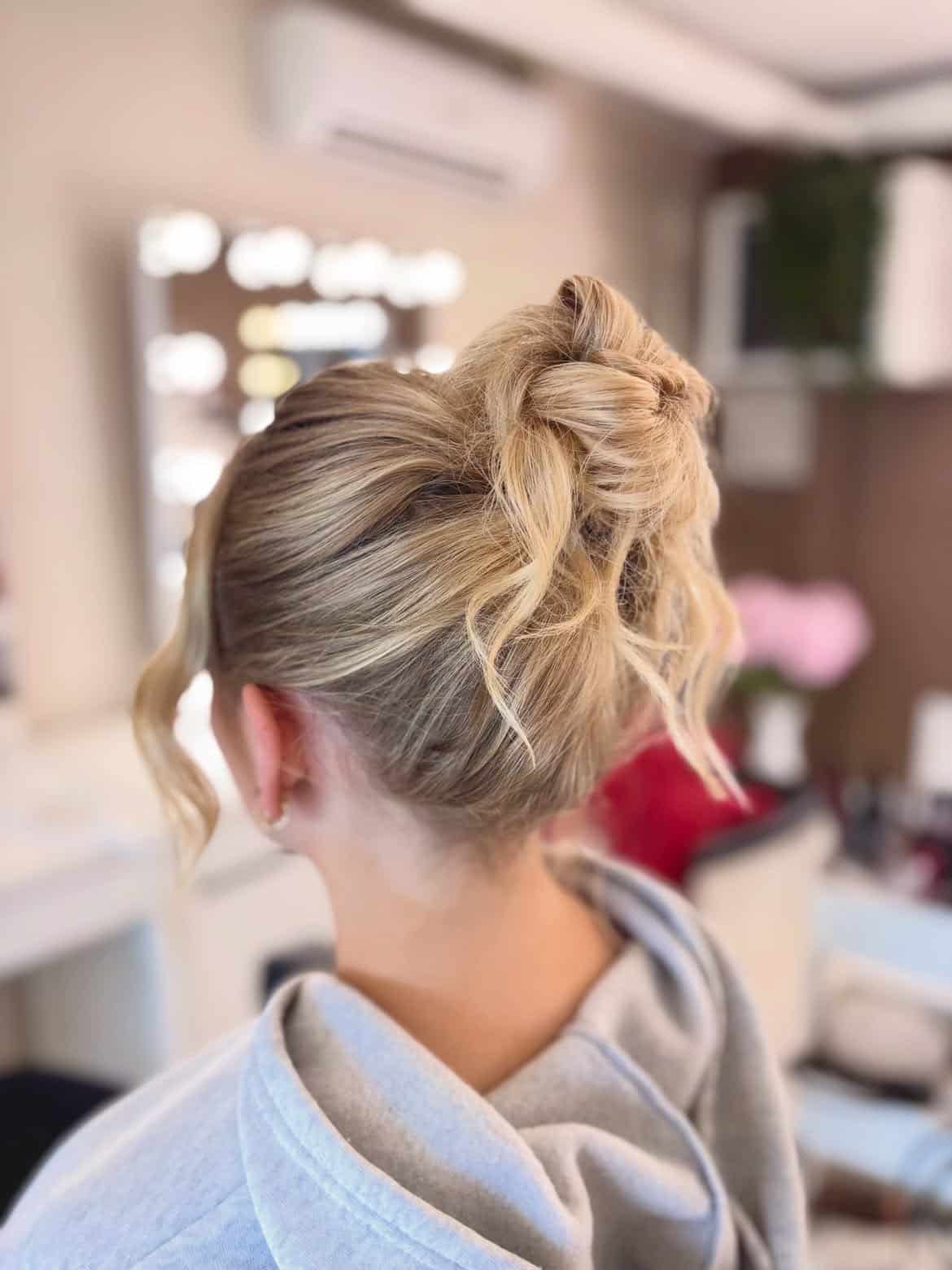 39. Messy Bun with Playful Strands