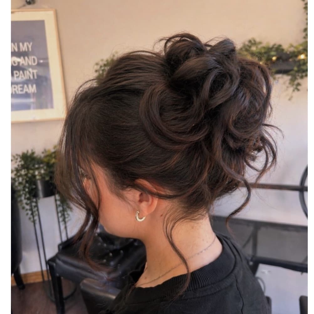 2. Messy Bun with Soft Waves